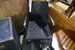 A modern chrome swivel office chair