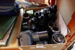 A box of cameras and lenses, including Olympus