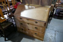 An old stripped pine bureau having three long graduated drawers