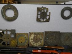 A quantity of antique brass clock faces and others