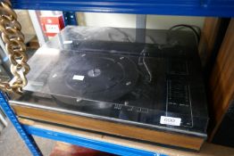 A vintage record turntable with speakers and various other audio equipment