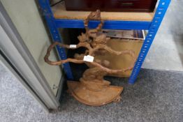 A cast iron whip stand decorated seated dog