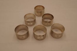 A quantity of six silver napkin rings marked 1-6 with engine turned design. Hallmarked London 1973,