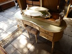 A painted kidney shape dressing table with triple mirror and sundry