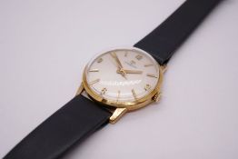 Tissot: a gent's 9ct yellow gold Tissot wristwatch with champagne dial on black leather strap, inscr