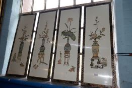 A set of four oriental wall plaques decorated vases and flowers