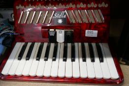 A Squirer SP10 amplifier, a Stella piano accordion and sundry