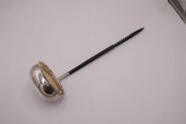 A silver ladle with twisted handle and silver top. Hallmarked Sheffield 1977, Francis Howard Ltd, wi