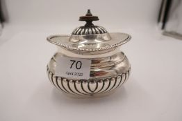 A half gadrooned Edwardian tea caddy with gadrooned lid and decorative border. A heavy piece of high