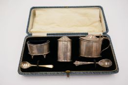 A cased silver salt set comprising two salts with Bristol blue inserts, and a pepper, hallmarked Che