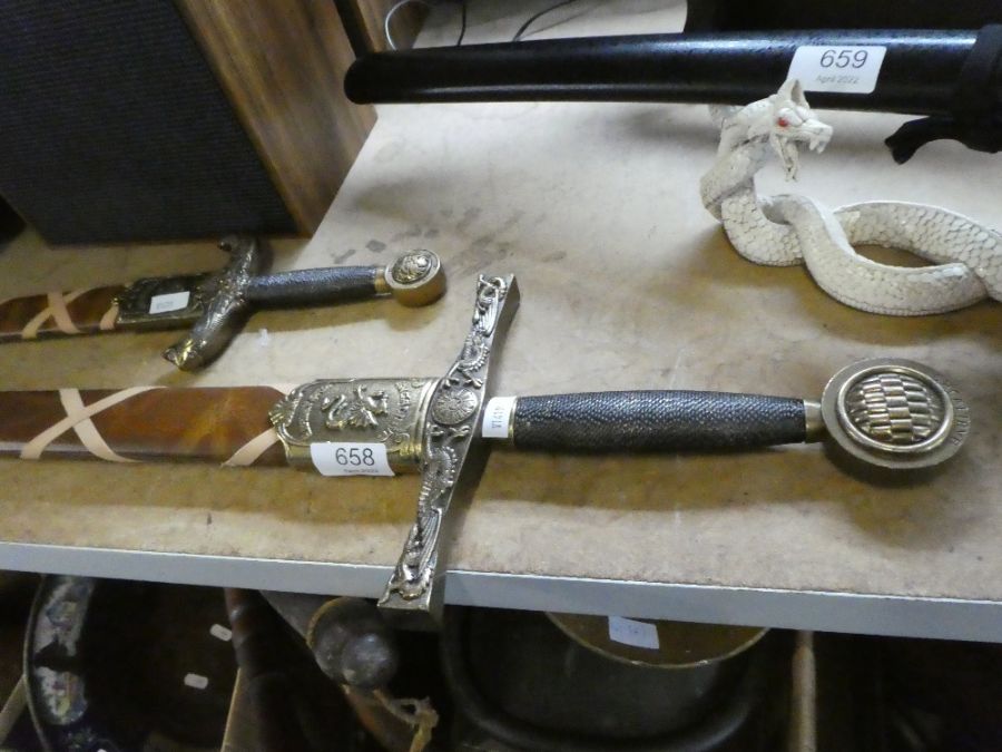 A reproduction of King Arthur's Excalibur sword and a smaller example