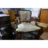 A French style stained beech open armchair with floral upholstery