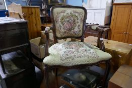 A French style stained beech open armchair with floral upholstery