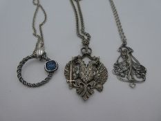 Three silver chains hung with large pendants, including one Art Nouveau pendant by Ari D Norman
