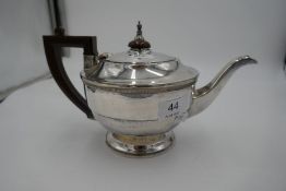 A Birmingham 1934 silver rounded teapot with girdled tapering body on a round, circular foot. Hallma