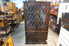 A reproduction oak display cabinet having two drawers with cupboard below