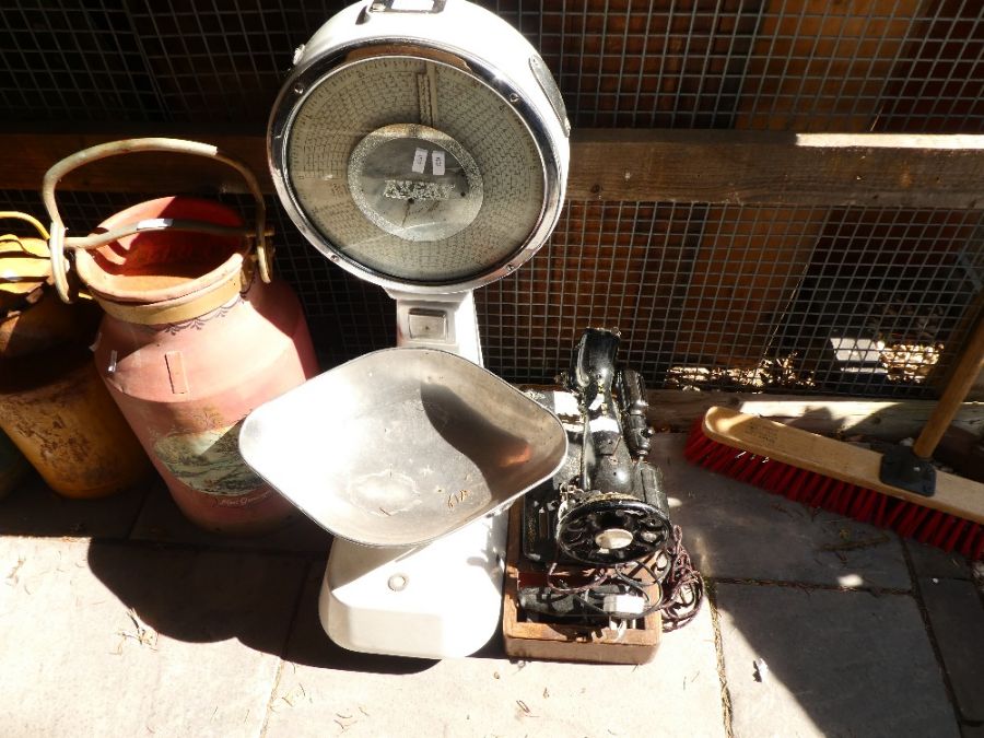 A shop counter set of weighing scales by Avery and a Singer sewing machine