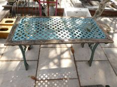 A garden table having pierced metal top