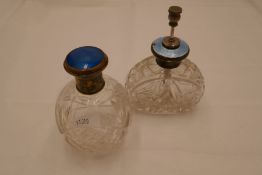 A sterling silver and enamel topped pretty cut glass scent atomiser. A decorative shape with ornate