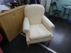 A modern cream upholstered armchair