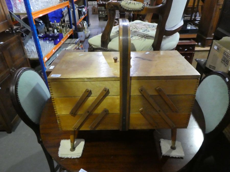 An old concertina sewing box on splay legs