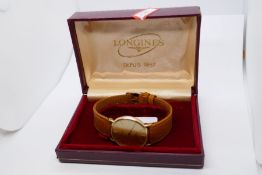 Longines: a boxed 9ct yellow gold gent's Longines wristwatch on tan leather strap, in Longines box