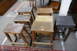 Seven various industrial/ commercial style stools, mainly pine in construction