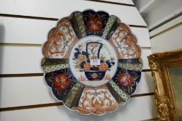 A Japanese Imari dish having shaped rim, the centre decorated basket of flowers, 36cm