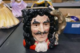 An antique Toby jug and two Royal Doulton character jugs