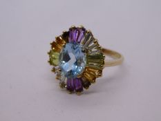 Modern 9ct yellow gold dress ring with central oval aquamarine, surrounded by multicoloured gem trap