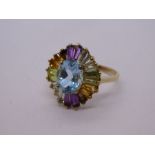 Modern 9ct yellow gold dress ring with central oval aquamarine, surrounded by multicoloured gem trap