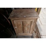 An old pine cupboard having paneled door