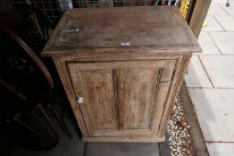 An old pine cupboard having paneled door