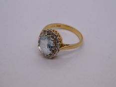 18ct yellow aquamarine and diamond cluster ring, with central oval aquamarine 9.5mm x 7.5mm, marked
