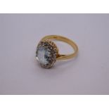 18ct yellow aquamarine and diamond cluster ring, with central oval aquamarine 9.5mm x 7.5mm, marked