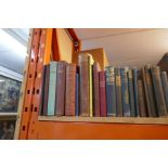 Shelf of antique and later leather bound and other books