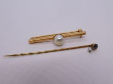 Antique 15ct yellow gold stick pin, marked 15ct inset with a sapphire hung with a seed pearl and yel