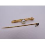 Antique 15ct yellow gold stick pin, marked 15ct inset with a sapphire hung with a seed pearl and yel