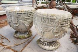 A pair of small reconstituted garden urns