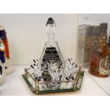 A glass Schnapps decanter with 6 glasses, having German WW2 decoration on a hexagonal mirrored tray