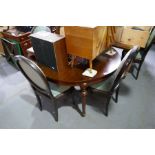 A French style mahogany dining table on turned legs and a set of six matching dining chairs