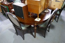 A French style mahogany dining table on turned legs and a set of six matching dining chairs