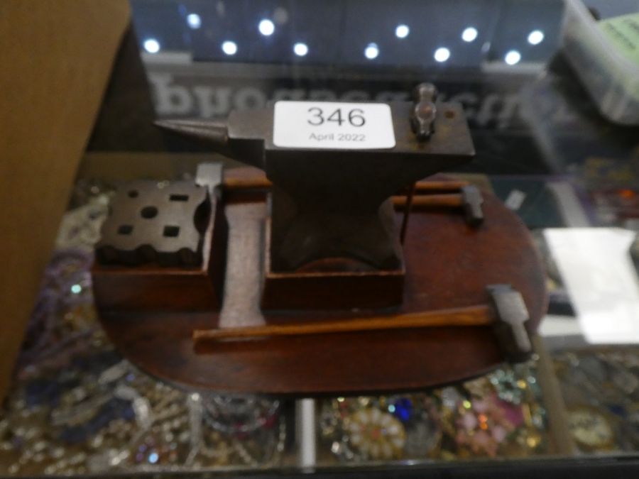 An old miniature modeller's anvil with hammers, on mahogany base and box of sundry