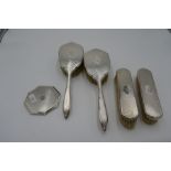 A silver engine turned dressing table set comprising four brushes. Hallmarked Birmingham 1937-1939,