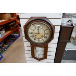 A circa 1900 walnut drop dial wall clock having octagonal surround