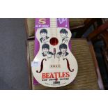 A Selcol Beatles guitar on reproduction cardboard back (guitar length 58cms)