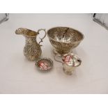 A quantity of four silver items to include a silver repousséd bowl on a circular foot with central v