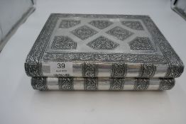 A white metal book design jewellery box with blue interior, mirror and compartments. Possibly Indian