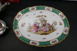 A Meissen oval platter having decoration of figures in garden setting, 42cm