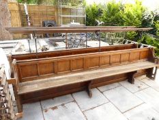 Two old Church pews, having panelled back with raised book shelf, 316cm